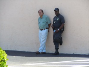 Joel Shumrak and the security guard always in the parking lot. Notice the Glock on his hip. 